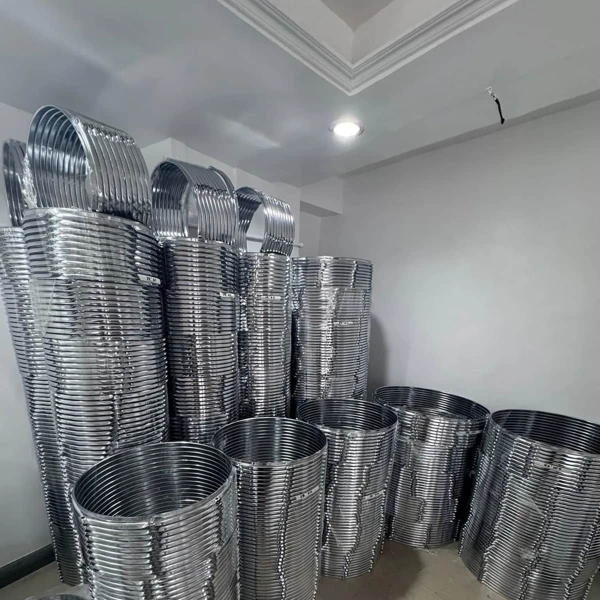 Chrome drum rings stacked against a wall